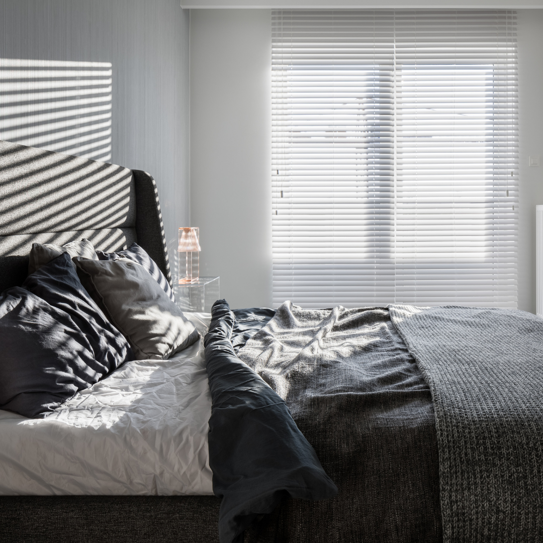 bedroom with white venetian blinds
